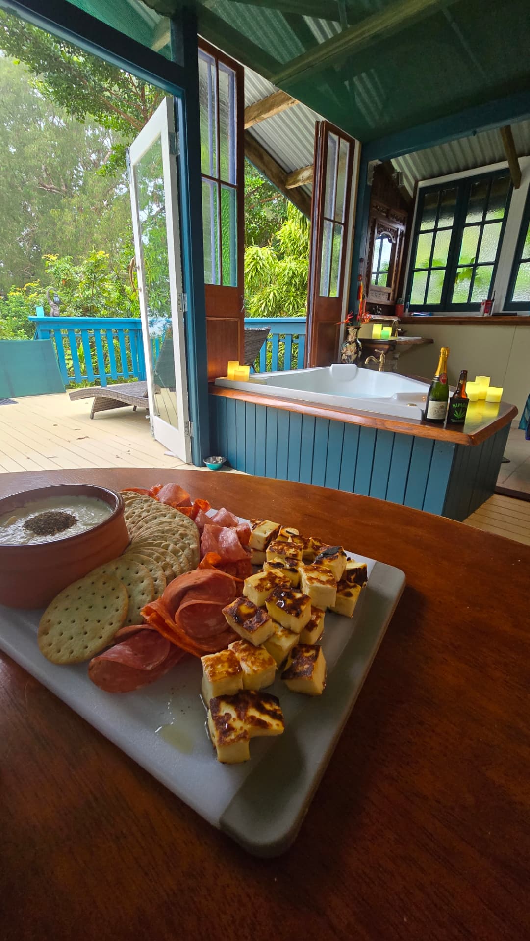 Spa bath with a grazing platter of cheese and cured meats