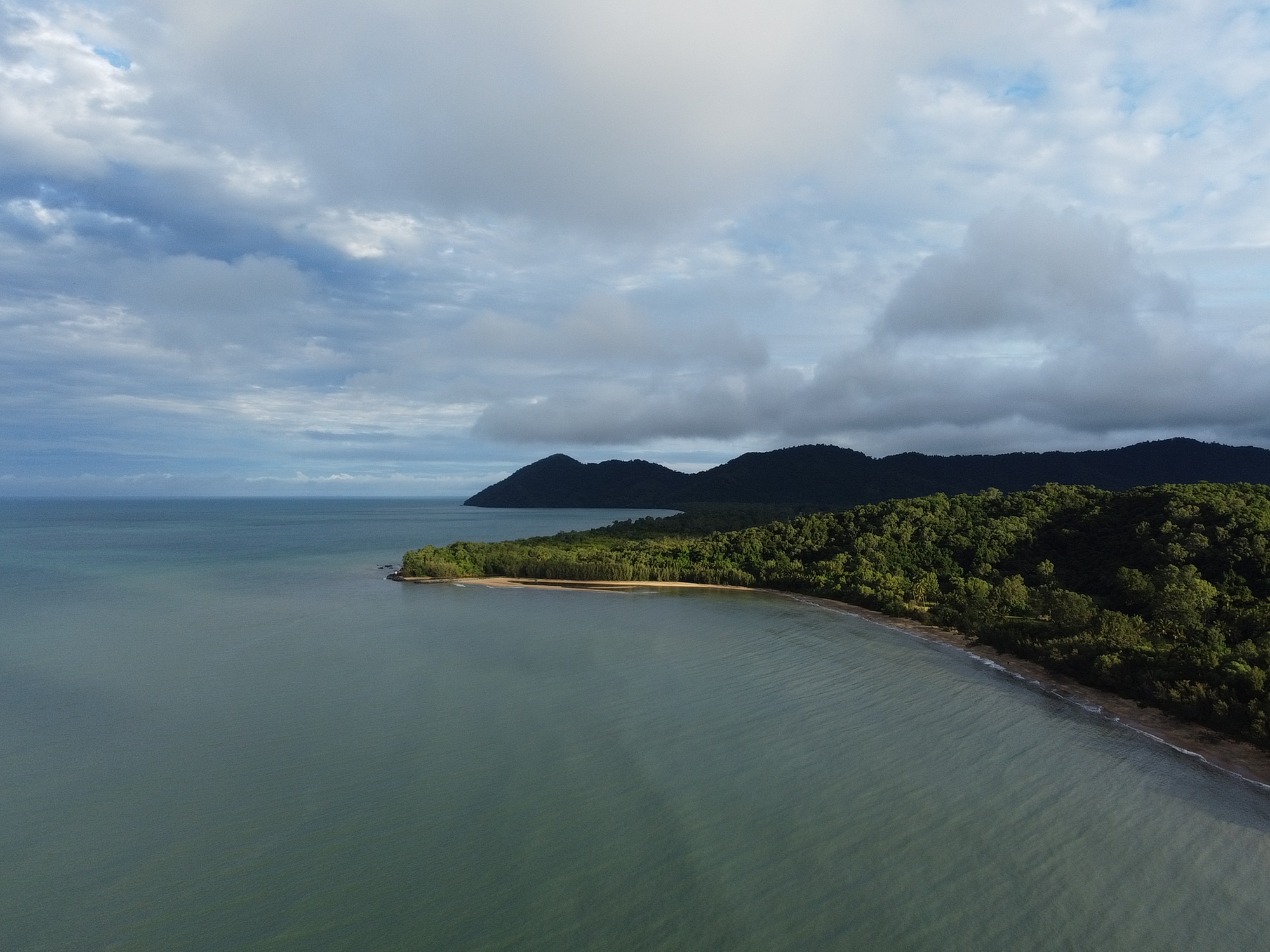 Aerial view of the rainforest headland and quiet shoreline