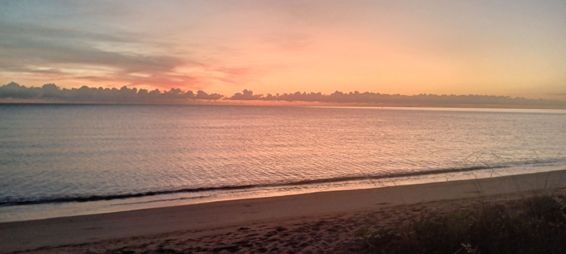 Sunrise glow over the Coral Sea at Bramston Beach