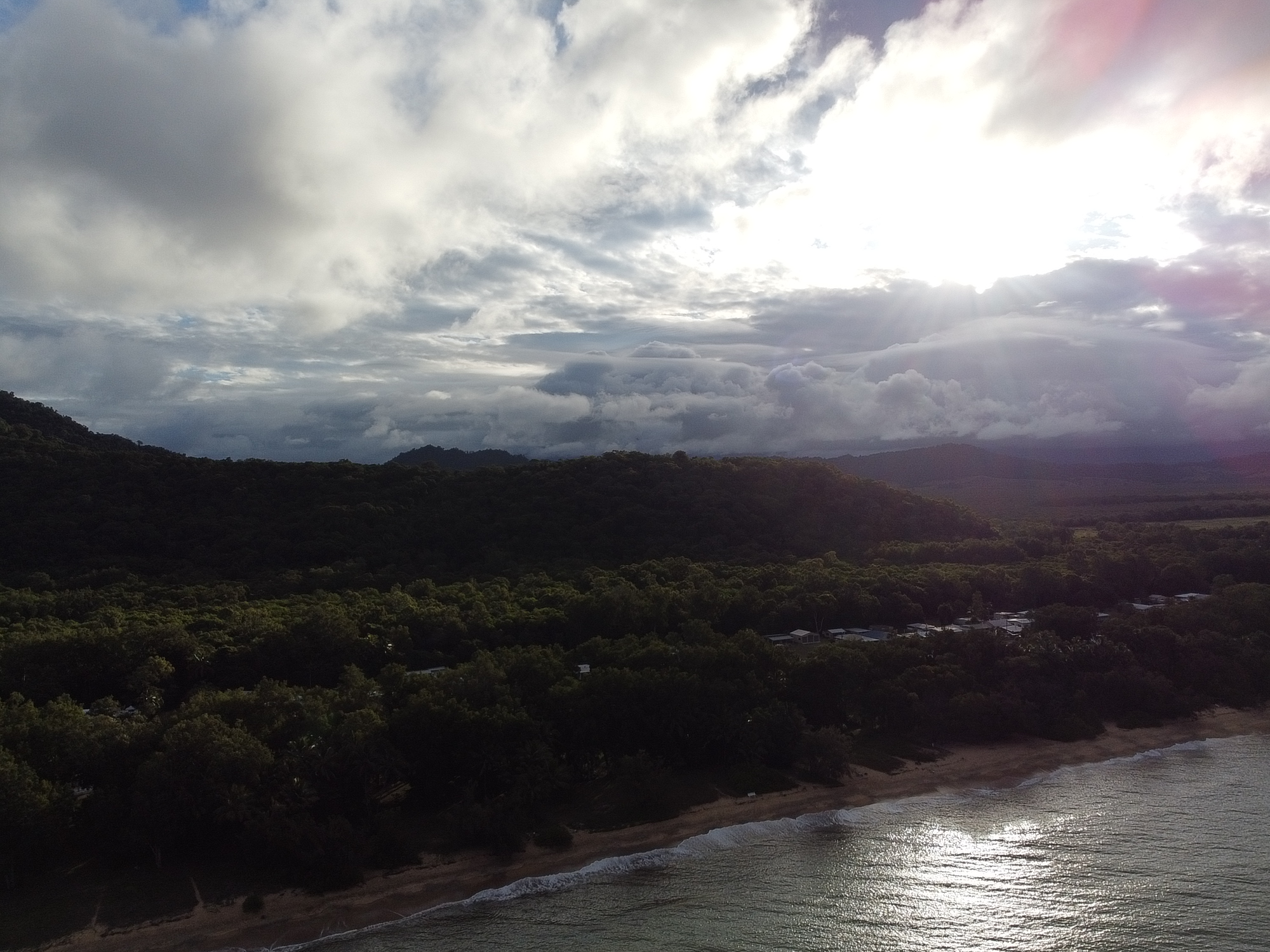 Aerial panorama of the Coral Sea meeting the rainforest shore