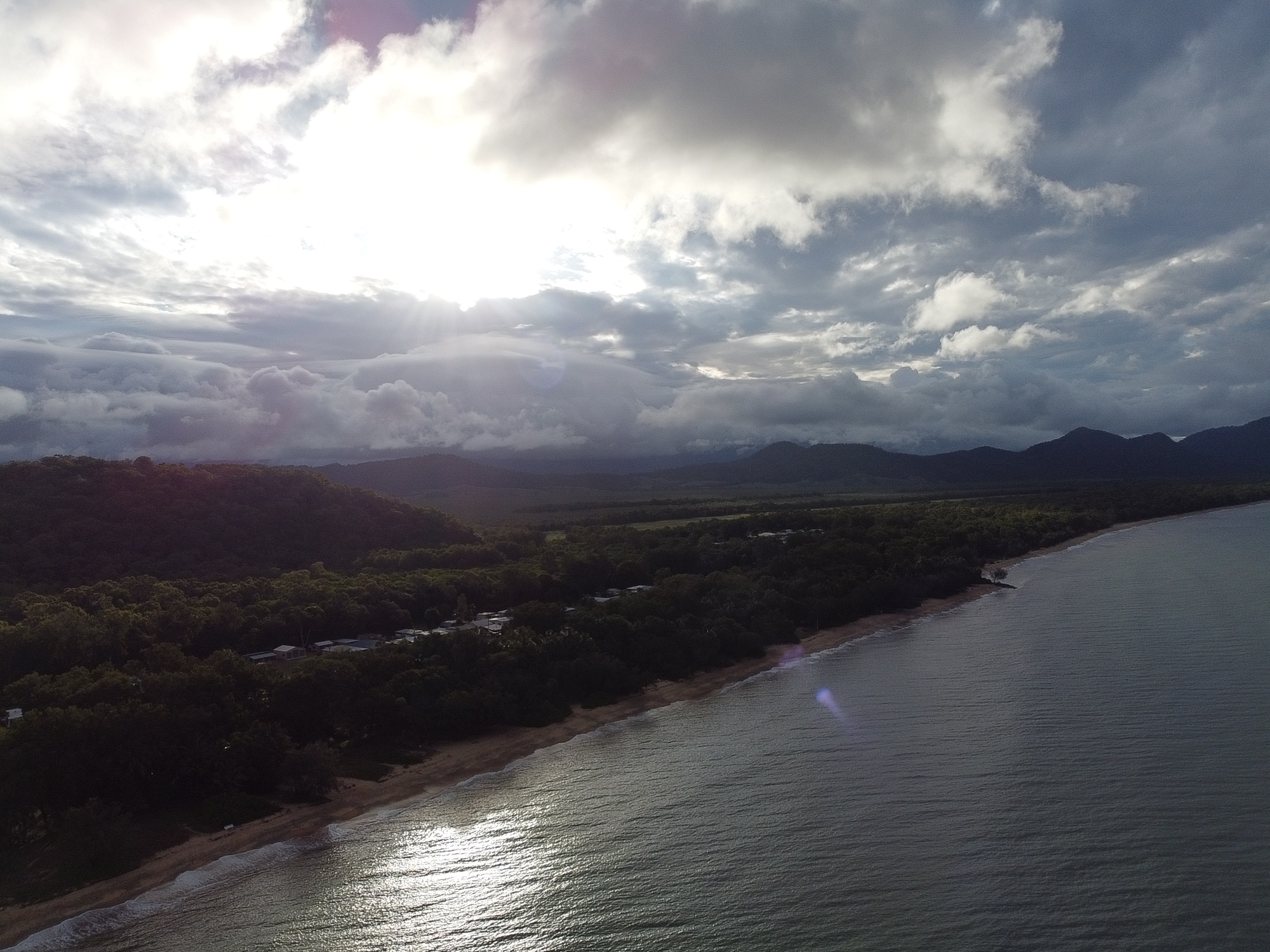 Aerial view of Bramston Beach coastline and rainforest mountains